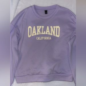 light purple sweatshirt with light yellow lettering